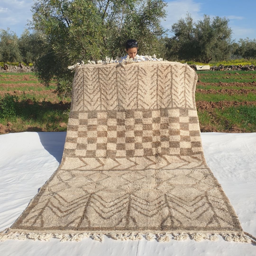 Soft 6x9 Beni Ourain Moroccan rug in ivory with beige chevron zigzag rows and ultra thick plush pile held outdoors